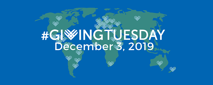 a 2-dimensional, army green world map on a medium blue background with light blue Giving Tuesday hearts scattered around and the words Giving Tuesday December 3, 2019 overlaying the ma[